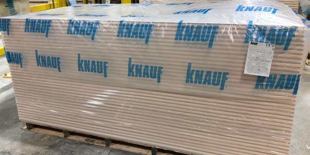 Knauf branded pallet hoods over a crate of plasterboard